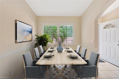 Dining room with arched walkways and light tile patterned floors. This photo is virtually staged.