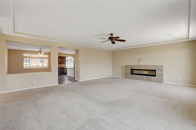 main living room: modern fireplace, ceiling fan, a