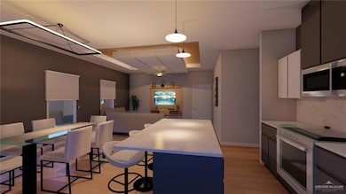 Kitchen featuring tasteful backsplash, decorative light fixtures, stainless steel microwave, electric stove, and light wood-style floors