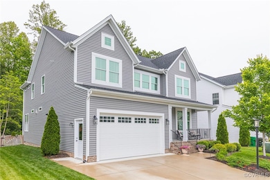 Traditional-style house with a garage, driveway, c