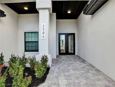 Property entrance featuring stucco siding and french doors