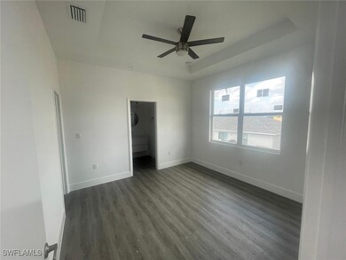 Unfurnished bedroom featuring visible vents, baseb