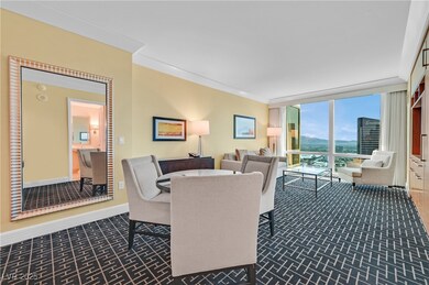Dining space with a wall of windows and dark carpet