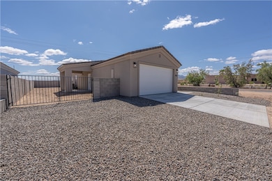 View of front of property featuring driveway, a ga