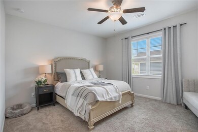 Bedroom with ceiling fan and carpet