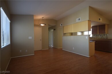 Spare room with lofted ceiling, visible vents, and