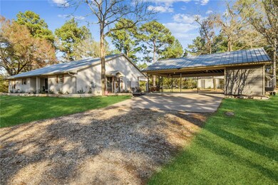 View of side of property featuring a carport and a