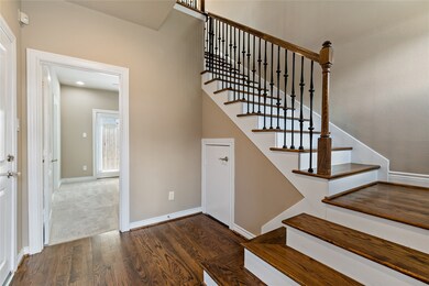 Enter into foyer with stairs featuring wrought iro