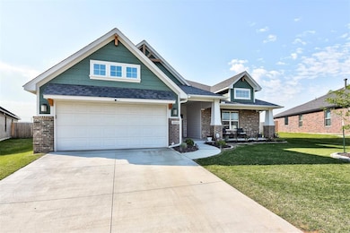 Craftsman-style house featuring a garage and a front lawn