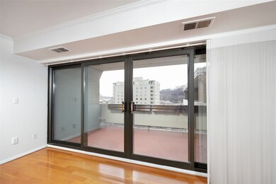 Large patio door leads to deck with view of Oaklan