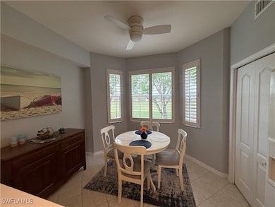 Dining room featuring ceiling fan, light tile patt