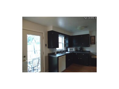 Another view of the kitchen that has a newer dishw