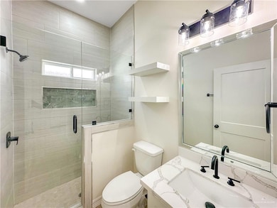 Full bathroom featuring a shower stall and vanity