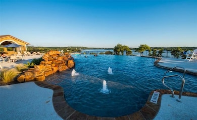 View of swimming pool featuring fence and a water
