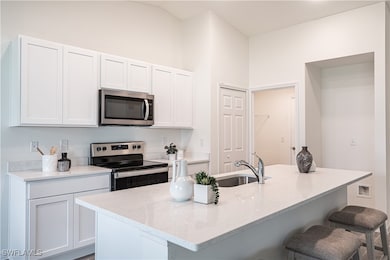 Kitchen featuring light stone countertops, a break