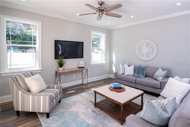 Family room, which is open to the kitchen, has sliders to the back patio and views of the pool.