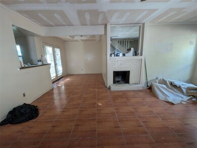 Unfurnished living room featuring dark tile patter