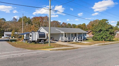 View of front of property featuring a porch and a front lawn