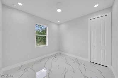 Empty room featuring baseboards, marble finish flo