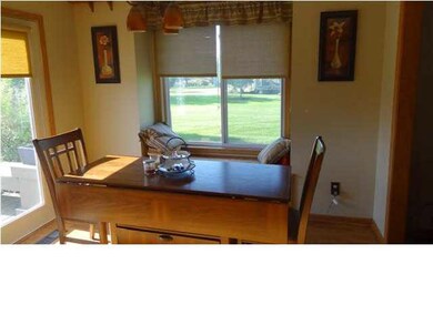 The dining room also has a window seat and a door 