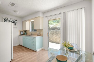 Kitchen featuring white appliances, light wood-st