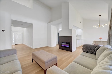 Living area featuring a chandelier, light wood-typ