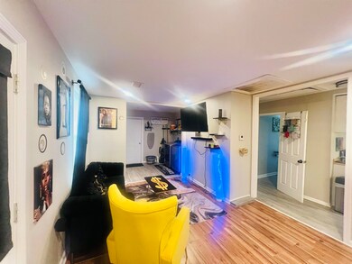 Living room with light hardwood / wood-style floor