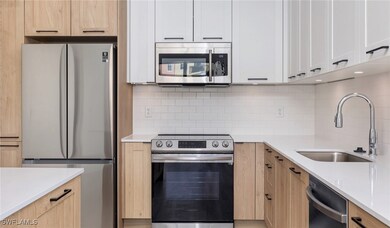 Kitchen with light brown cabinets, a sink, light c