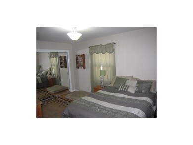 Spacious Master bedroom, hard wood floors with a d
