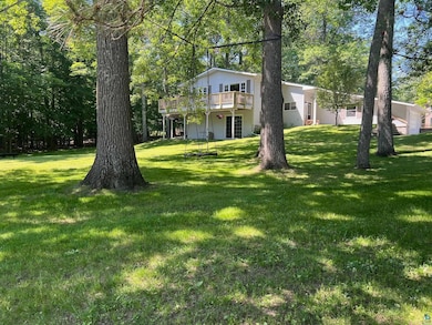 View of green lawn with a wooden deck