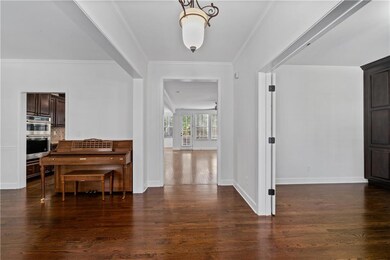 Entryway featuring crown molding and dark wood-style floors