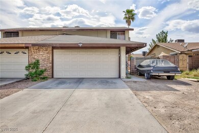 View of property featuring fence, driveway, and st