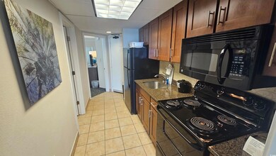 Kitchen featuring light tile patterned floors, dar