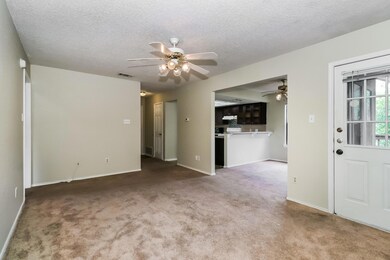Unfurnished living room with ceiling fan, a textu