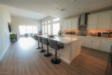 Kitchen featuring wall chimney exhaust hood, stain