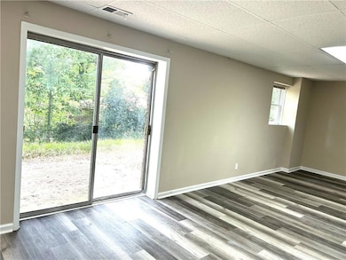 Spare room with dark hardwood / wood-style floors,
