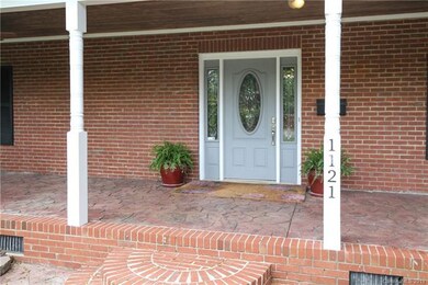 Wide front porch spans the full length of the hous