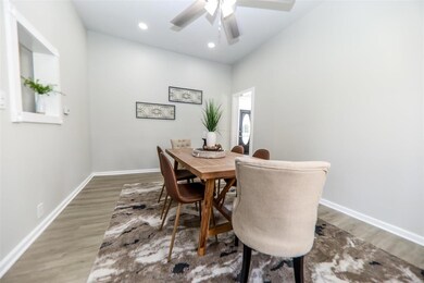 Dining space with ceiling fan and wood-type flooring