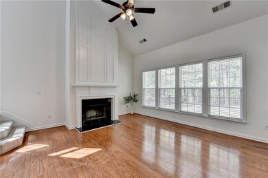 Unfurnished living room with high vaulted ceiling, ceiling fan, a large fireplace, and visible vents