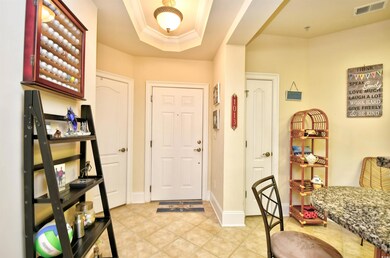 Entrance foyer featuring light tile patterned flooring and baseboards