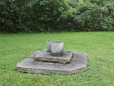 View of former gas well scheduled to be plugged at no charge to buyer. Concrete slabs will go away.