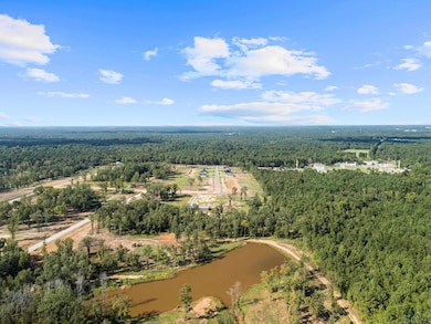 Aerial view of a heavily wooded area and a nearby body of water