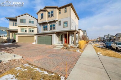 Brick driveway that leads to a 2-car attached gara