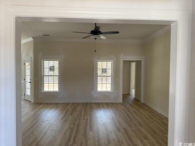 Empty room featuring crown molding, hardwood / woo