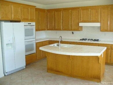 Gourmet Kitchen features center island, dual ovens