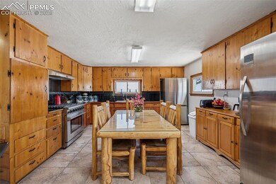 Kitchen featuring brown cabinets, under cabinet ra