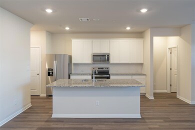 Kitchen with tasteful backsplash, visible vents, 