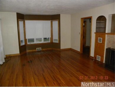 Living room with hardwood floors and wood burning 
