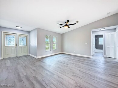 Entryway featuring baseboards, light wood-type flo
