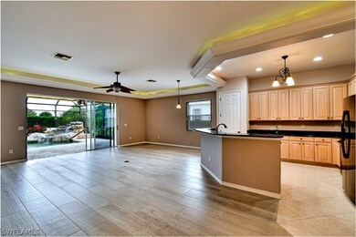 Open concept living area is so versatile. Pool table, bar, dining, family room- you choose! Watch t.v., entertain or just listen to the sound of the waterfall feature in the pool while you cook.